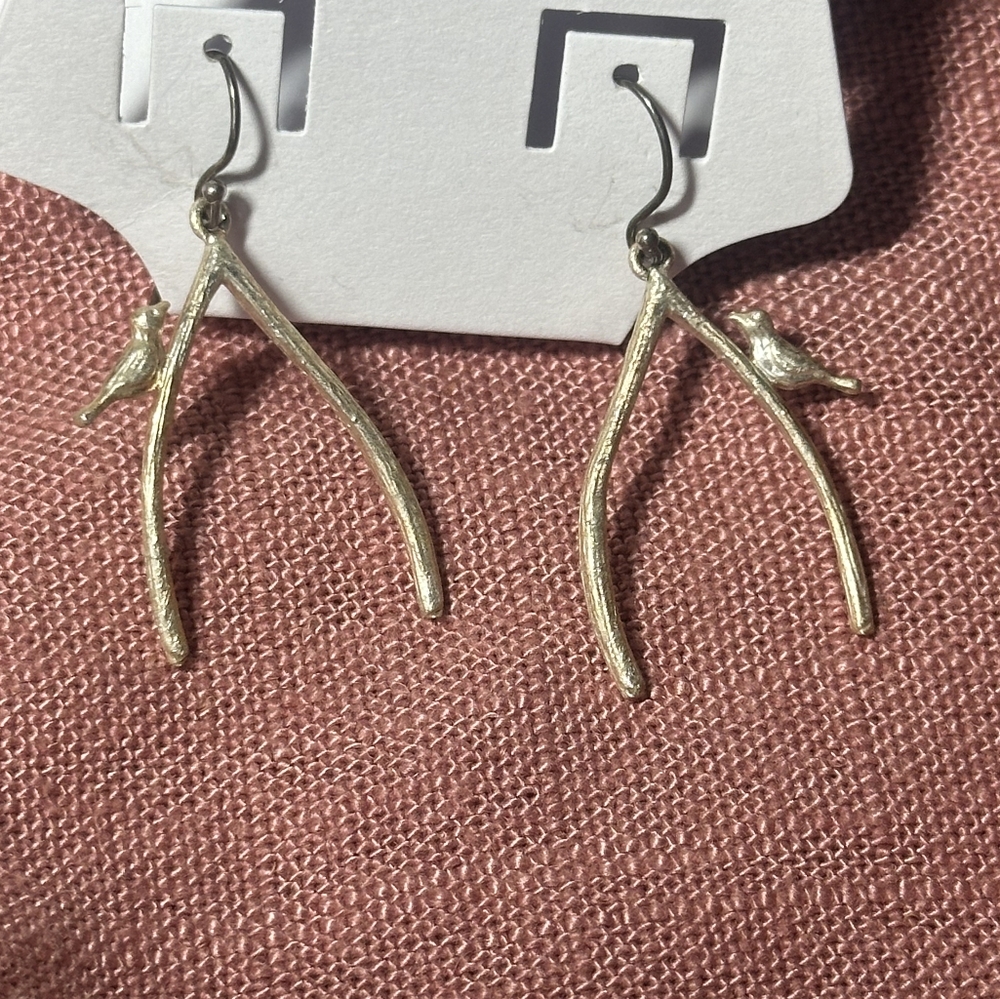 Silver colored bird on a branch earrings